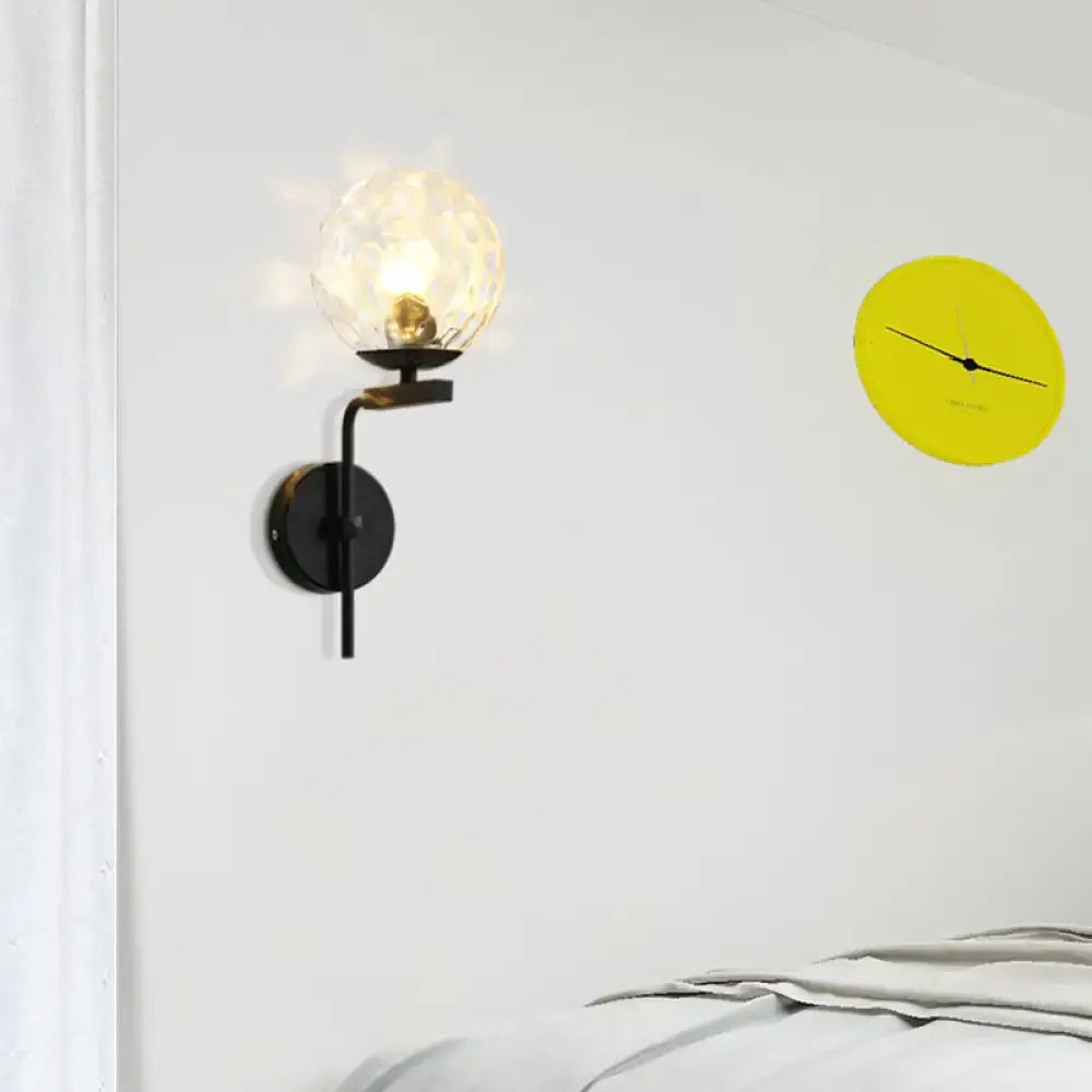 Contemporary black metal wall mount lighting with a textured frosted glass globe for bedroom use