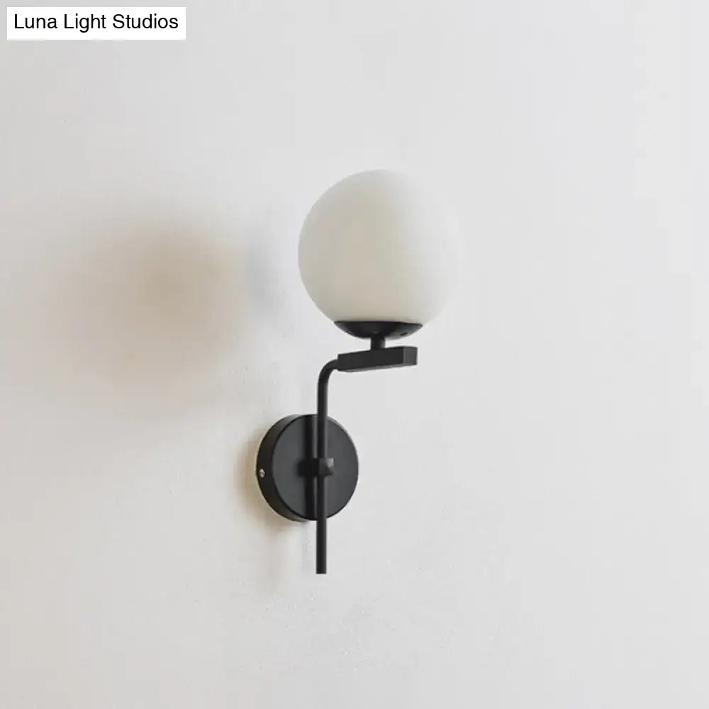 Contemporary black metal wall mount lighting with frosted white glass spherical shade for bedroom use