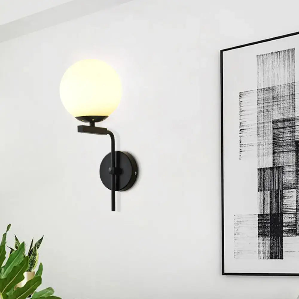 Contemporary black metal wall mount lighting with frosted glass globe shade for bedroom use