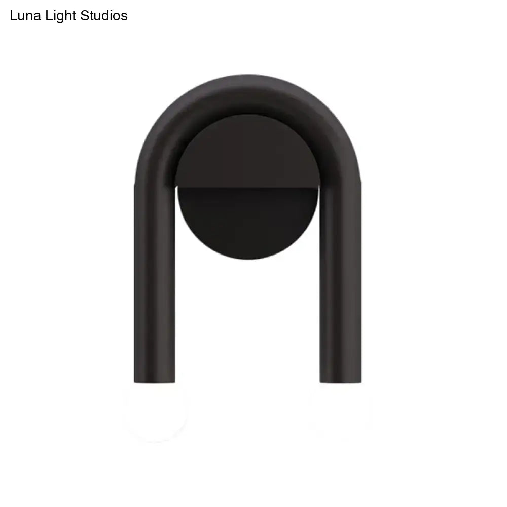 Contemporary black matte u-shaped light fixture wall sconce with sleek minimalist design for bedroom use