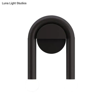 Contemporary black matte u-shaped light fixture wall sconce with sleek minimalist design for bedroom use