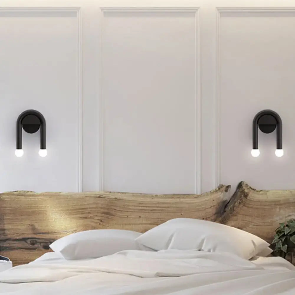 Contemporary black u-shaped light fixture bedroom wall sconce with dual exposed bulbs in a modern design