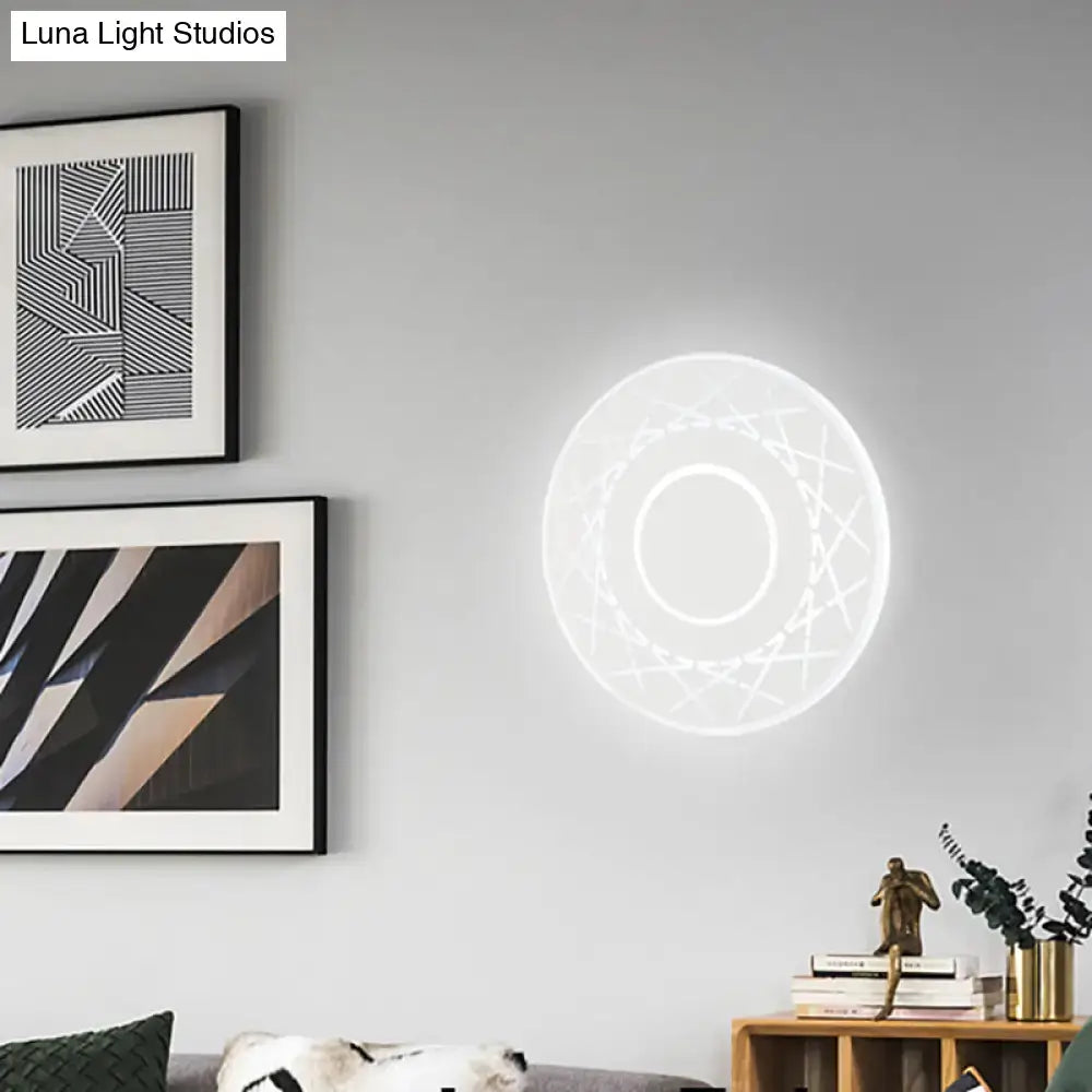Contemporary black and white geometric wall lamp with glowing white light and intricate pattern for living room