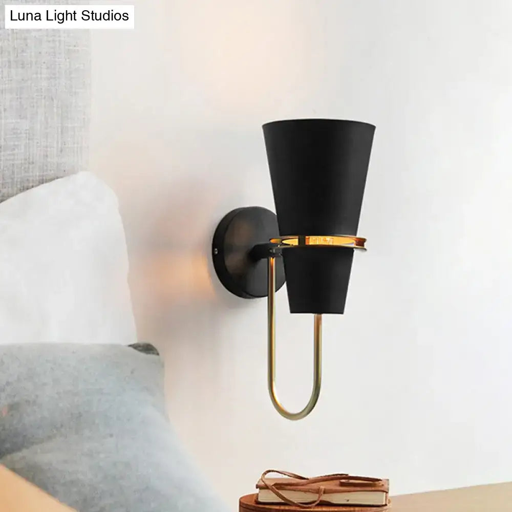 Contemporary black conical wall sconce light with gold-toned metal bracket and accent ring for bedroom use