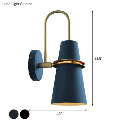 Contemporary blue and gold flared wall sconce light with brass accents and gold-lined interior for bedroom use