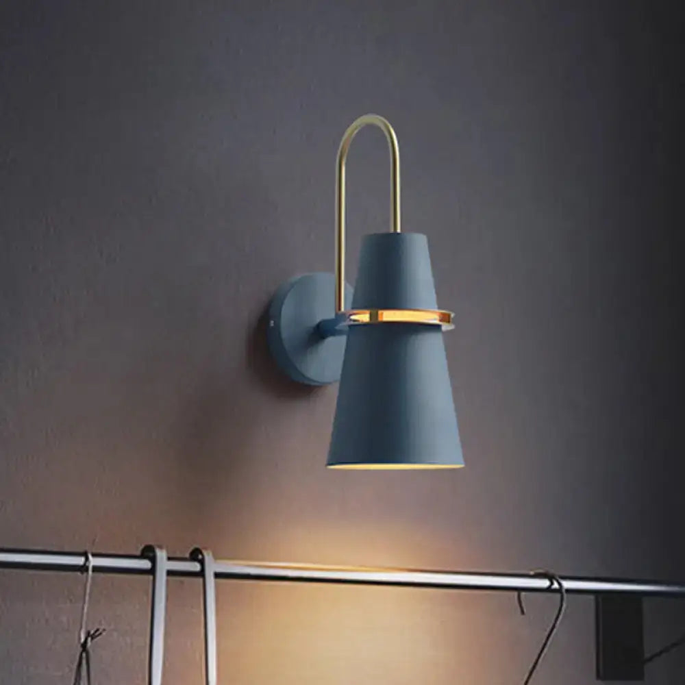 Contemporary blue and gold flared wall sconce light with a conical shade and curved gold-toned arm for bedroom use