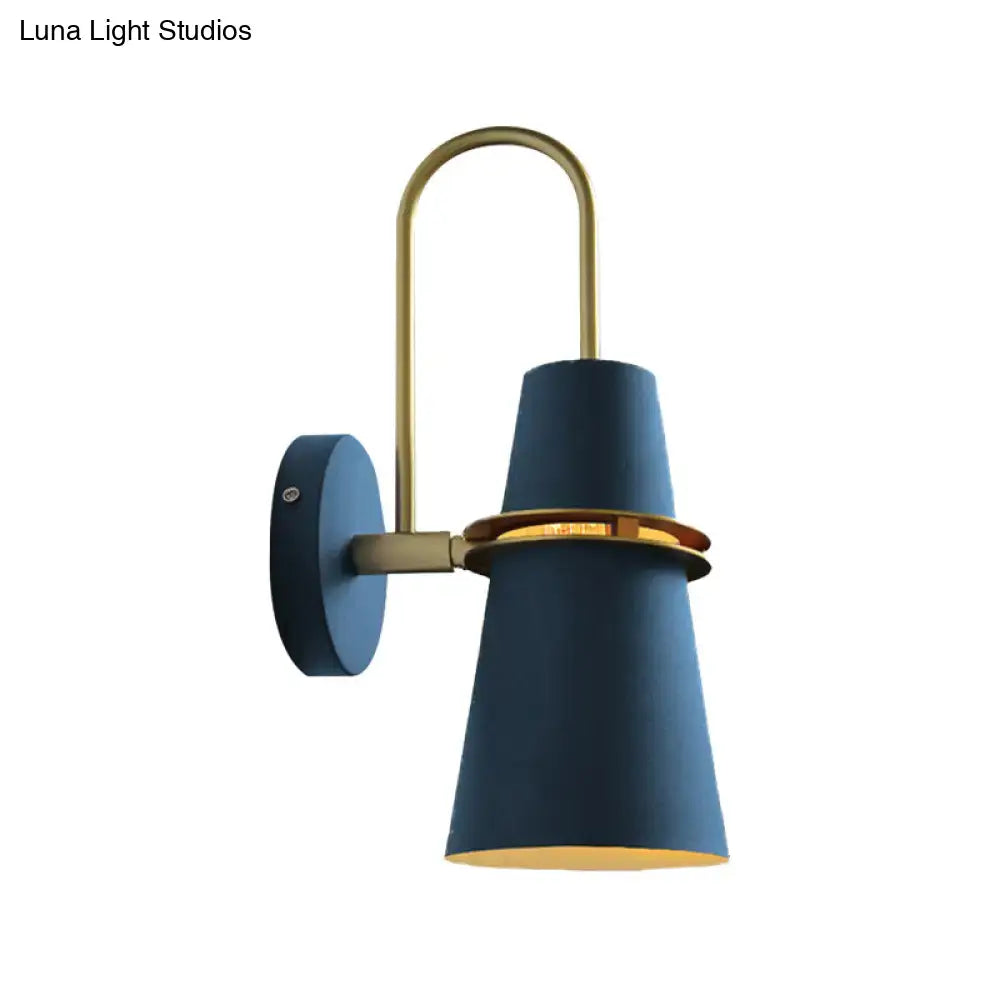Contemporary blue and gold flared wall sconce light with brass accents and curved arm for bedroom lighting