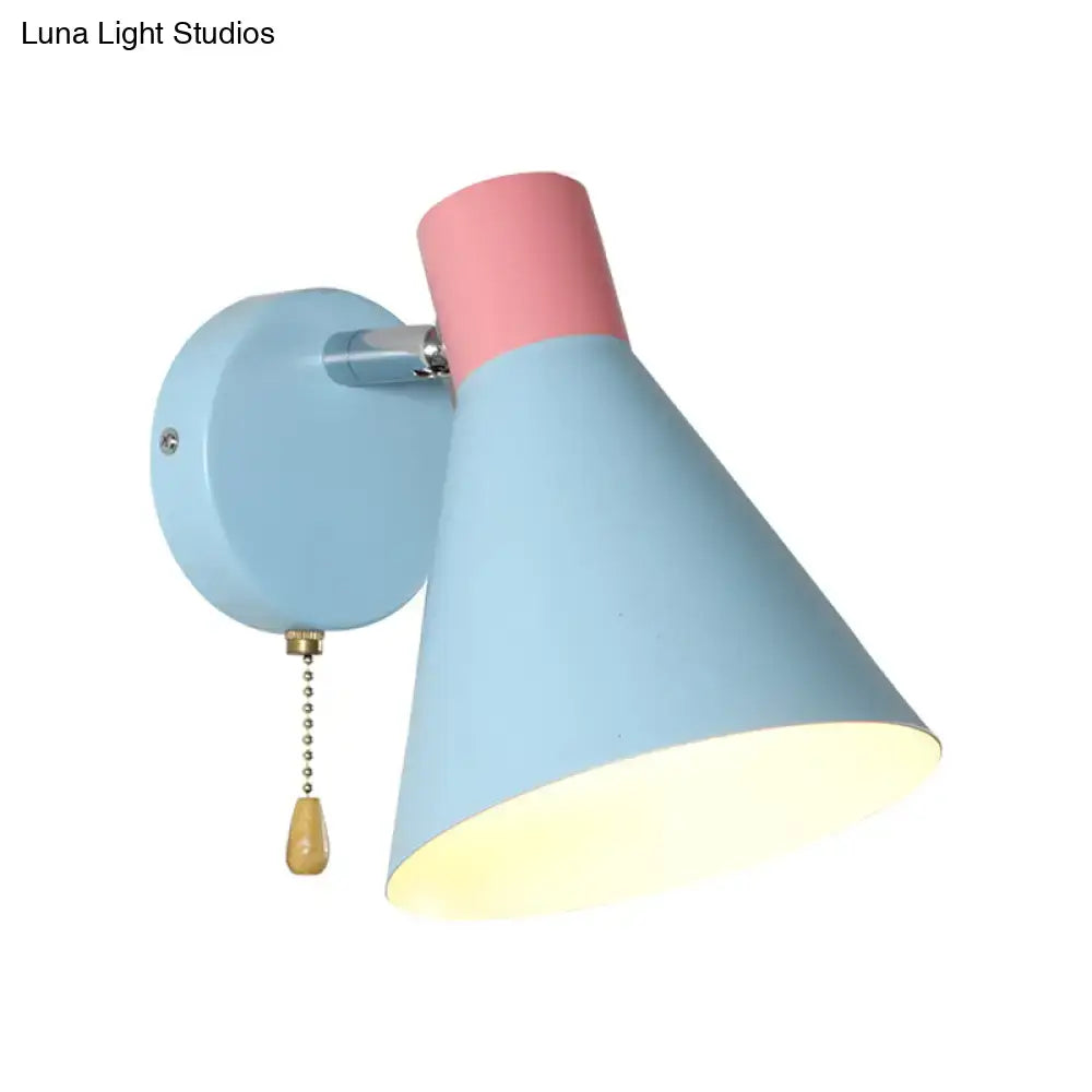 Contemporary pastel blue and pink two-tone direct wired metal sconce with conical shade and brass pull chain for bedroom use