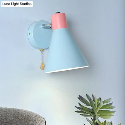Contemporary blue and pink metal conical wall sconce with brass pull chain and direct wired installation for bedrooms