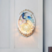 Contemporary blue and white peacock wall sconce with gold floral accents and crystal ball for living room living space