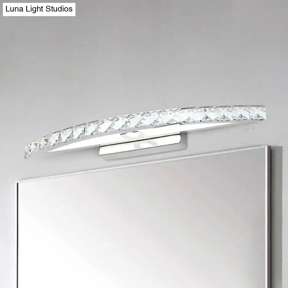 Contemporary bow shaped vanity lighting wall sconce with clear crystal accents and polished chrome finish for bathroom