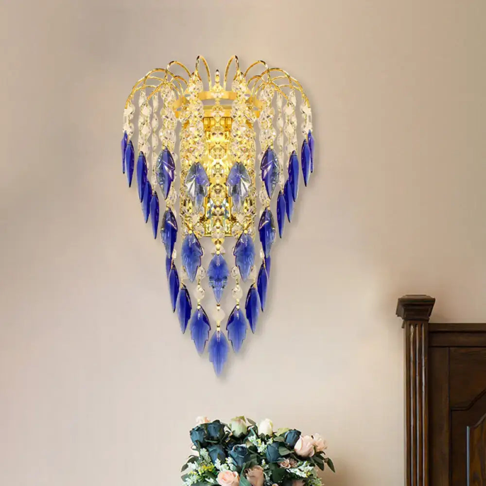 Contemporary brass wall lamp with gold-toned frame and cascading blue and clear crystal droplets for extra light
