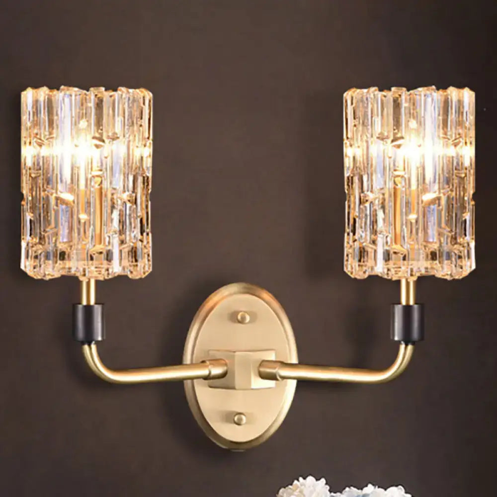 Contemporary gold-toned bedside wall sconce with clear crystal shade and two crystal-encrusted cylindrical shades