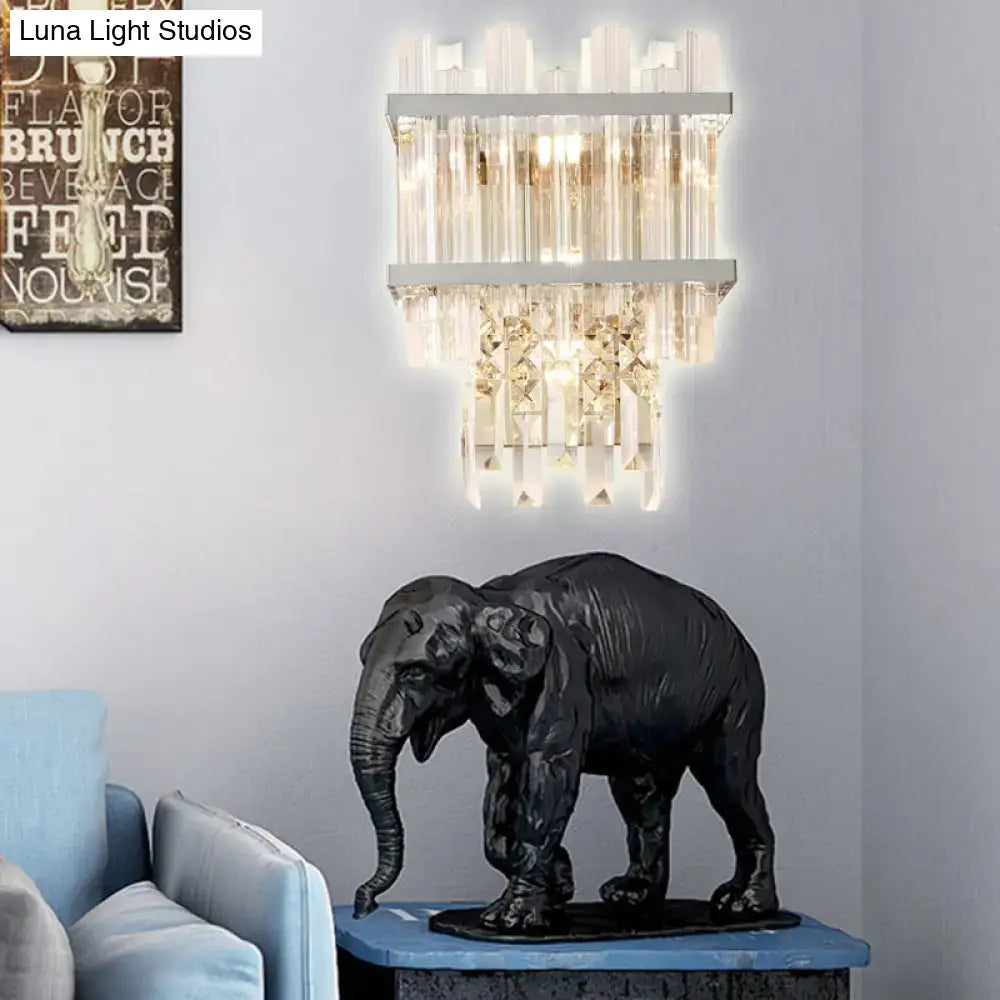 Black elephant sculpture with textured surface on blue marble base featured with contemporary brass chrome wall lamp