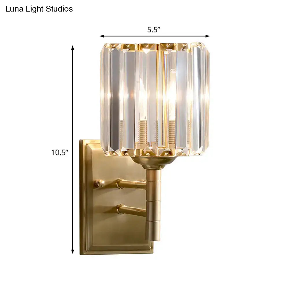 Contemporary brass wall sconce with gold finish and faceted crystal shade for bedroom lighting