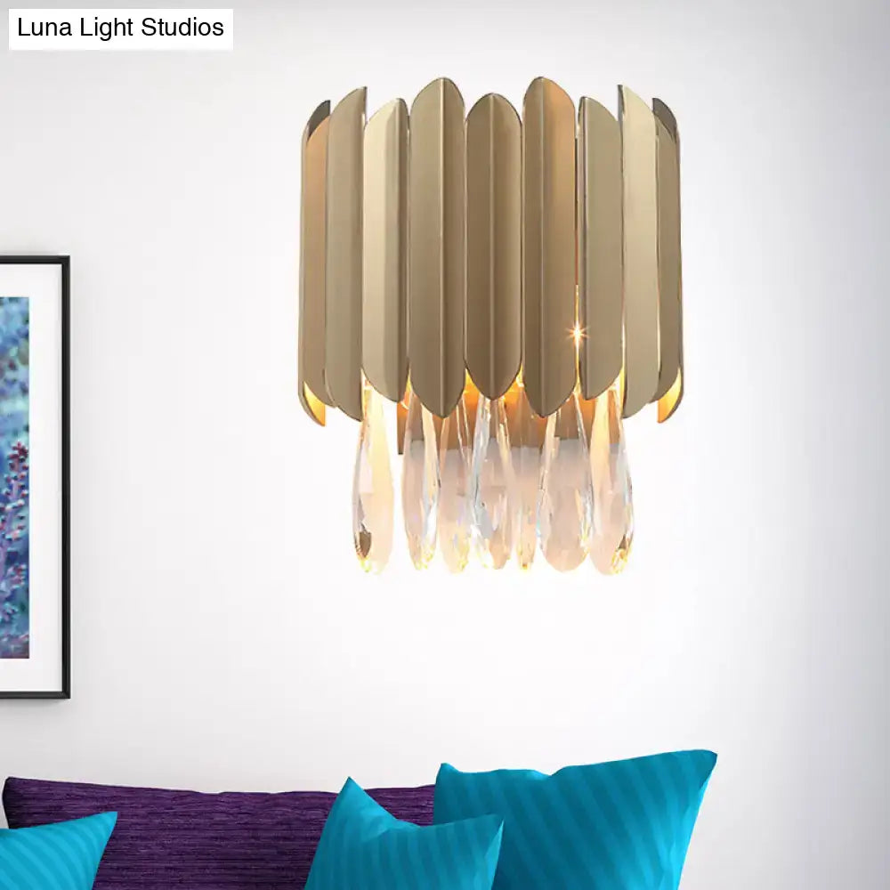 Contemporary brass finish wall lamp with gold-toned metallic sconce and cascading crystal droplets for living room