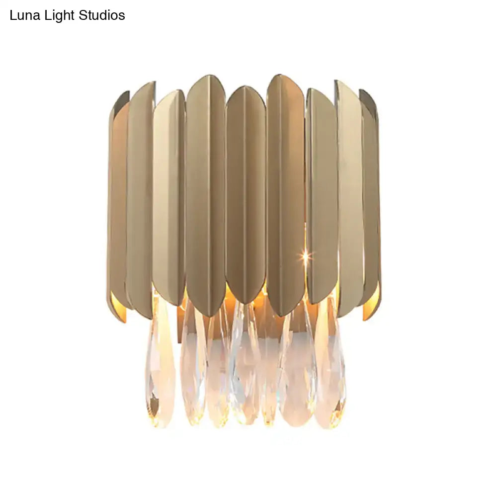 Contemporary brass finish wall lamp with gold-toned leaf panels and crystal teardrop pendants for living rooms