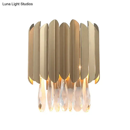 Contemporary brass finish wall lamp with gold-toned leaf panels and crystal teardrop pendants for living rooms