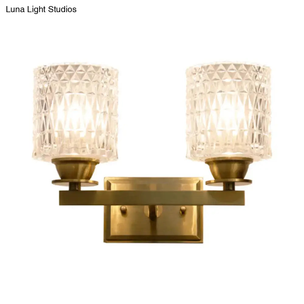 Brass-finished wall light with two faceted crystal glass shades direct wired electric power source