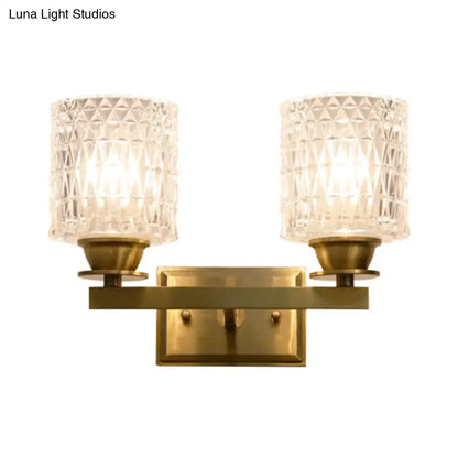 Brass-finished wall light with two faceted crystal glass shades direct wired electric power source