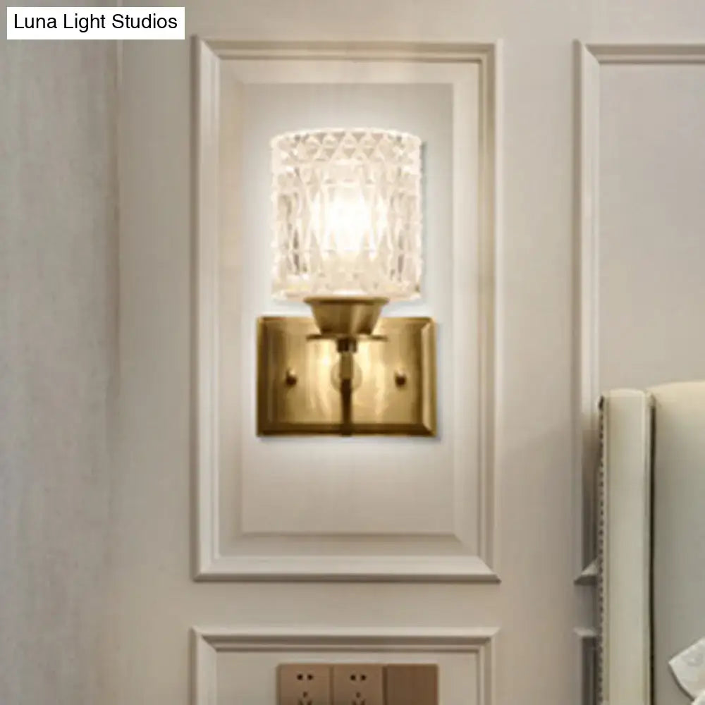 Vintage-style wall light with brass lattice metal base and faceted crystal glass shade direct wired electric power source