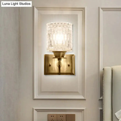 Vintage-style wall light with brass lattice metal base and faceted crystal glass shade direct wired electric power source