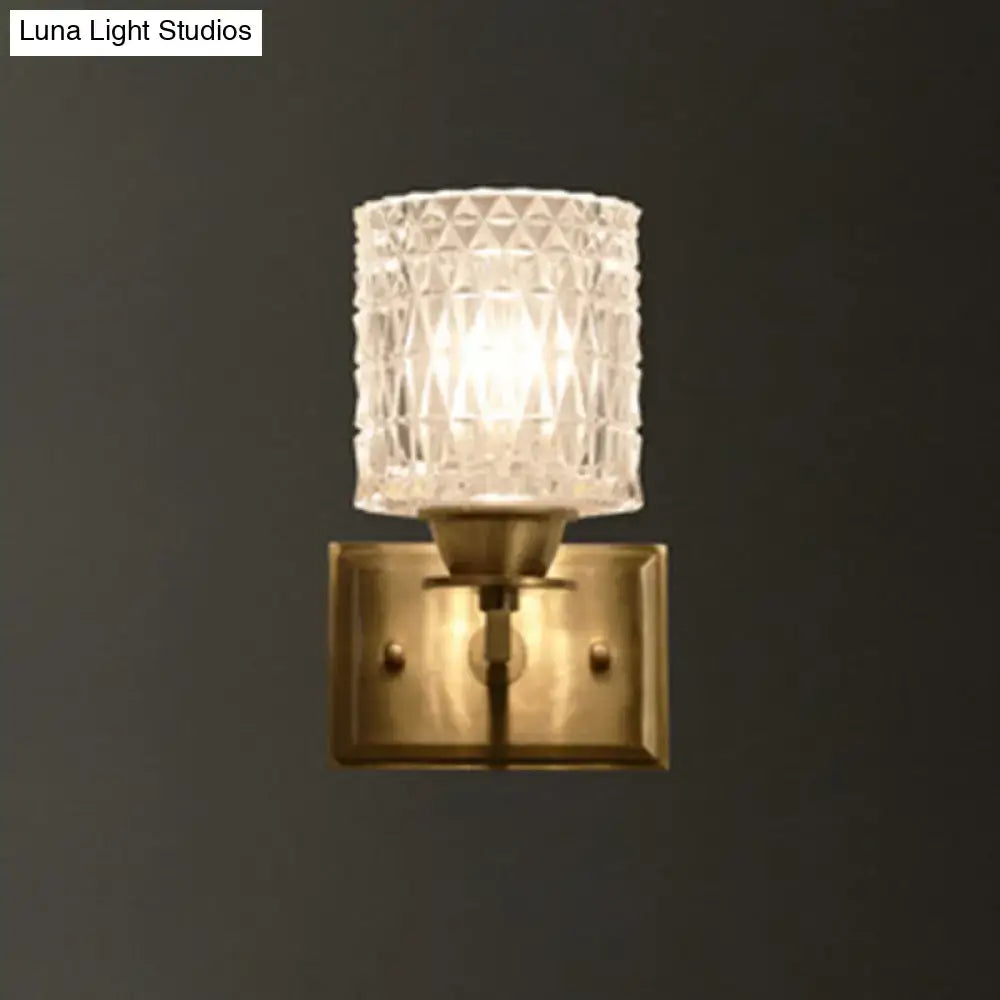 Contemporary brass lattice glass wall light with clear faceted glass lampshade and direct wired electric power source