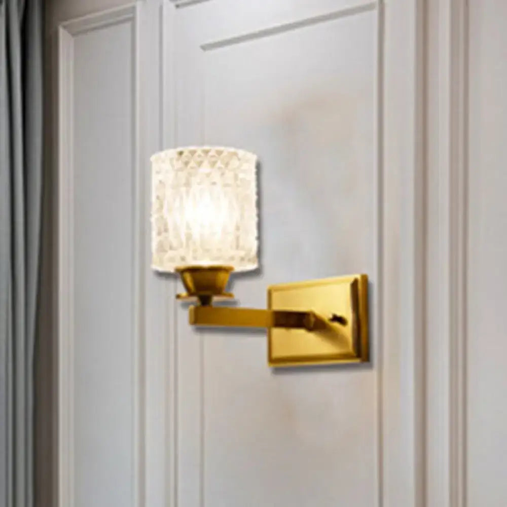 Gold-finished contemporary brass lattice glass wall light with textured translucent shade and direct wired electric power source