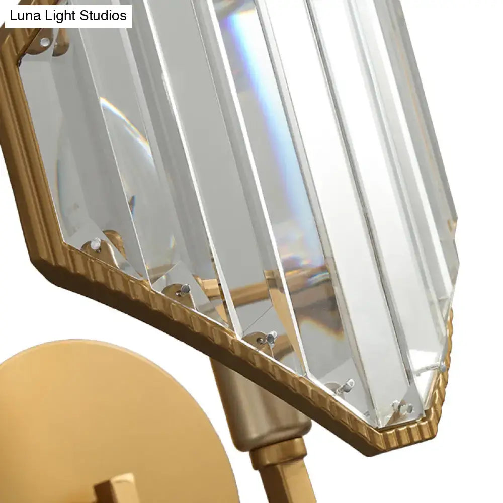 Contemporary brass rhombus wall sconce with gold-toned frame and clear crystal prism panels for bedroom lighting