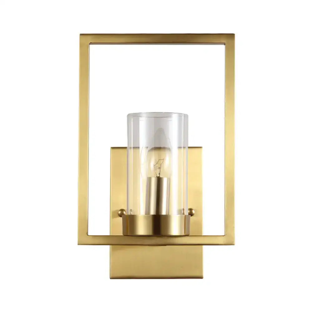 Contemporary brass wall light with a clear glass cylinder and exposed bulb light fixture for bedroom use