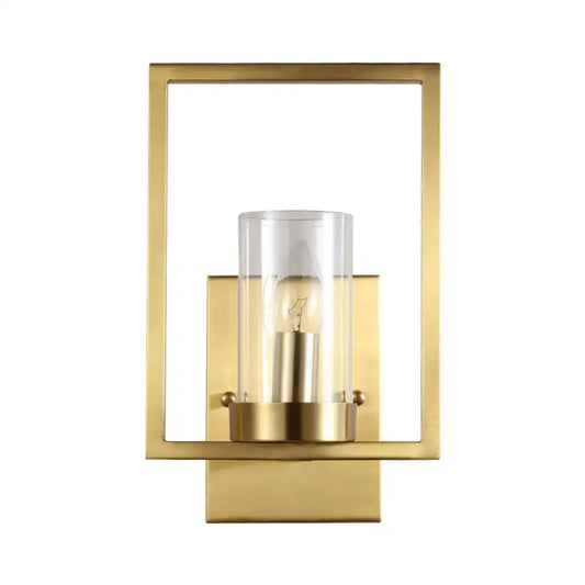 Contemporary brass wall light with a clear glass cylinder and exposed bulb light fixture for bedroom use