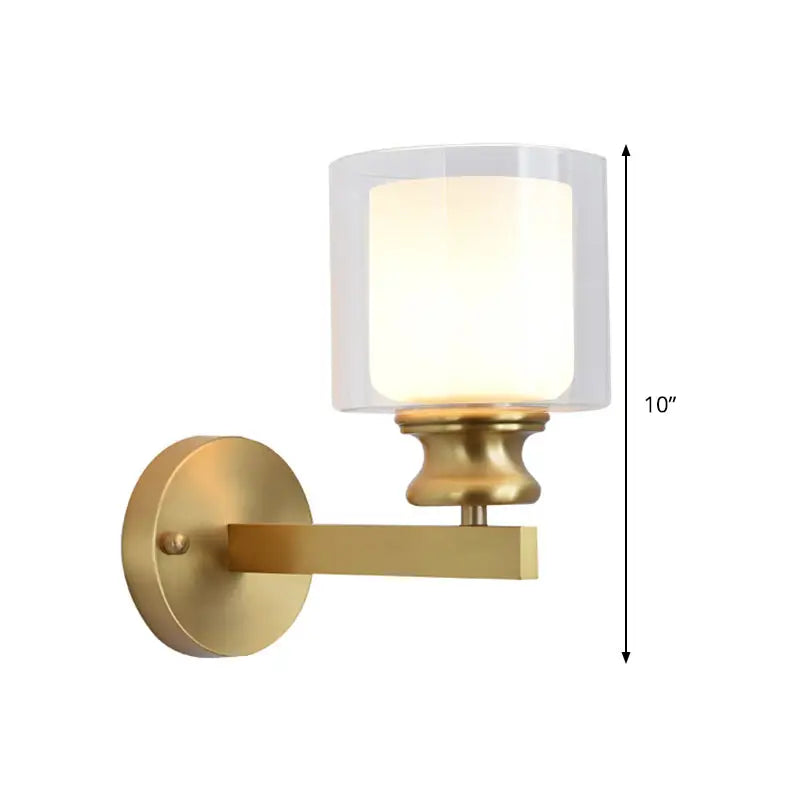Gold finished brass wall mounted light fixture with cylindrical frosted glass shade for contemporary living room use