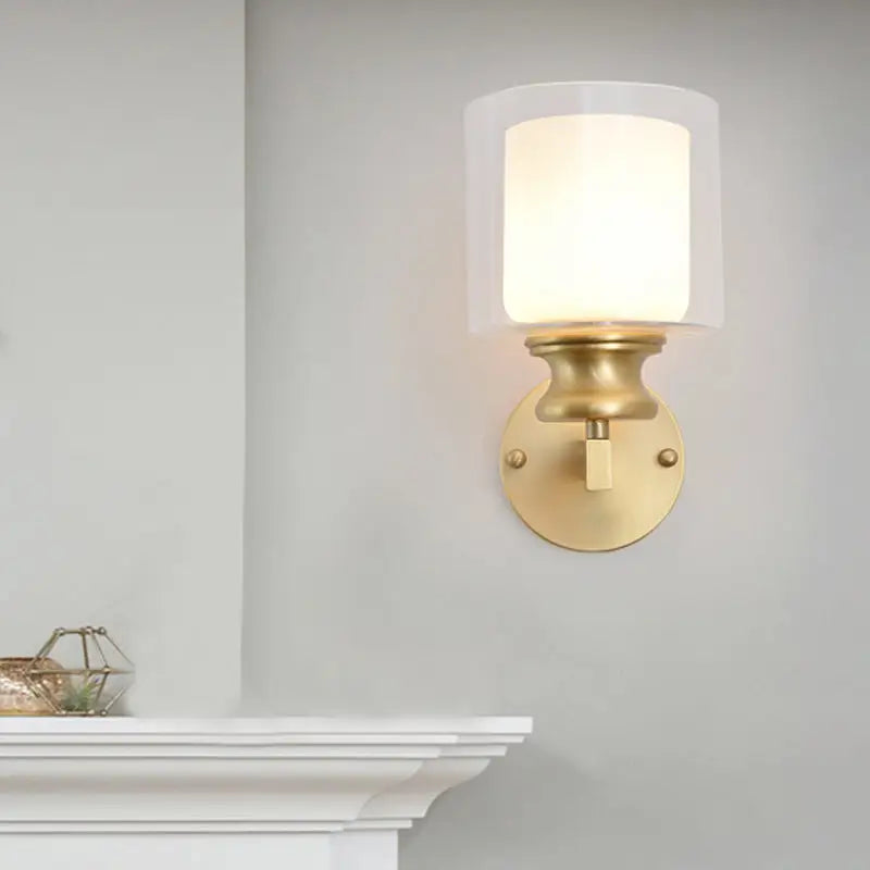 Contemporary brass wall mounted light fixture with frosted glass shade in gold tone for living room use