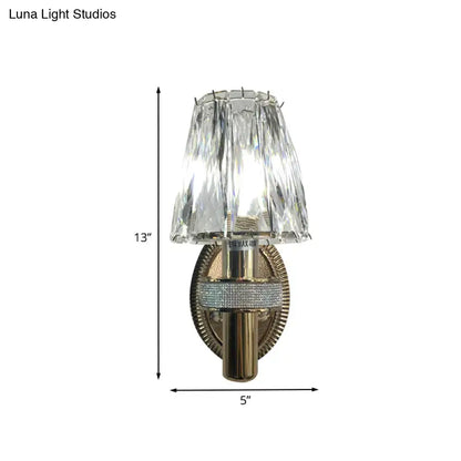 Contemporary bronze wall sconce light with 13-inch faceted crystal shade and gold-toned base with rhinestone band