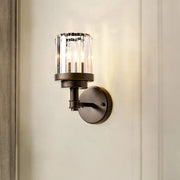 Contemporary bronze wall sconce with ribbed crystal shade and dark bronze cylindrical glass light fixture for hallways