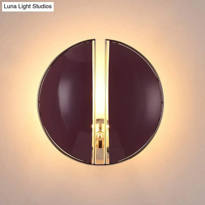 Contemporary burgundy and gold wall lamp with a sleek circular design and central gold-toned light strip