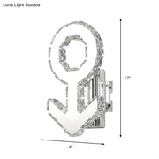 Contemporary chrome wall lamp with crystal-encrusted anchor design and warm white light, featuring sleek fixture height