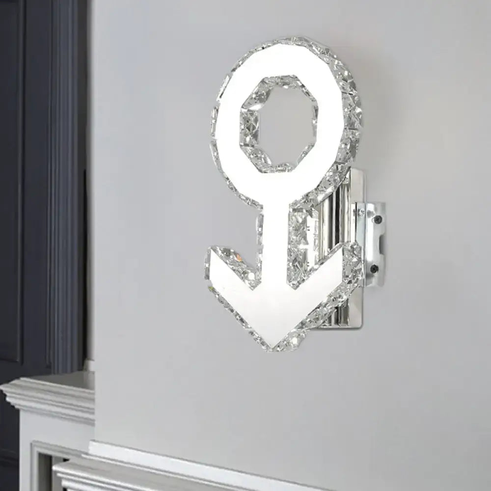 A sleek contemporary chrome wall lamp shaped like an anchor with crystal outline and warm white light
