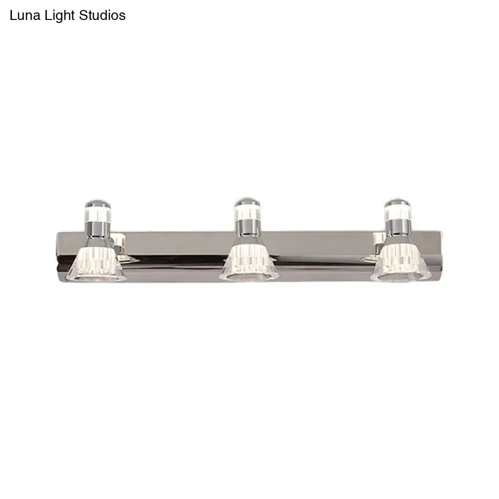 Contemporary style chrome conic sconce light with three clear crystal accents for bathroom vanity lighting
