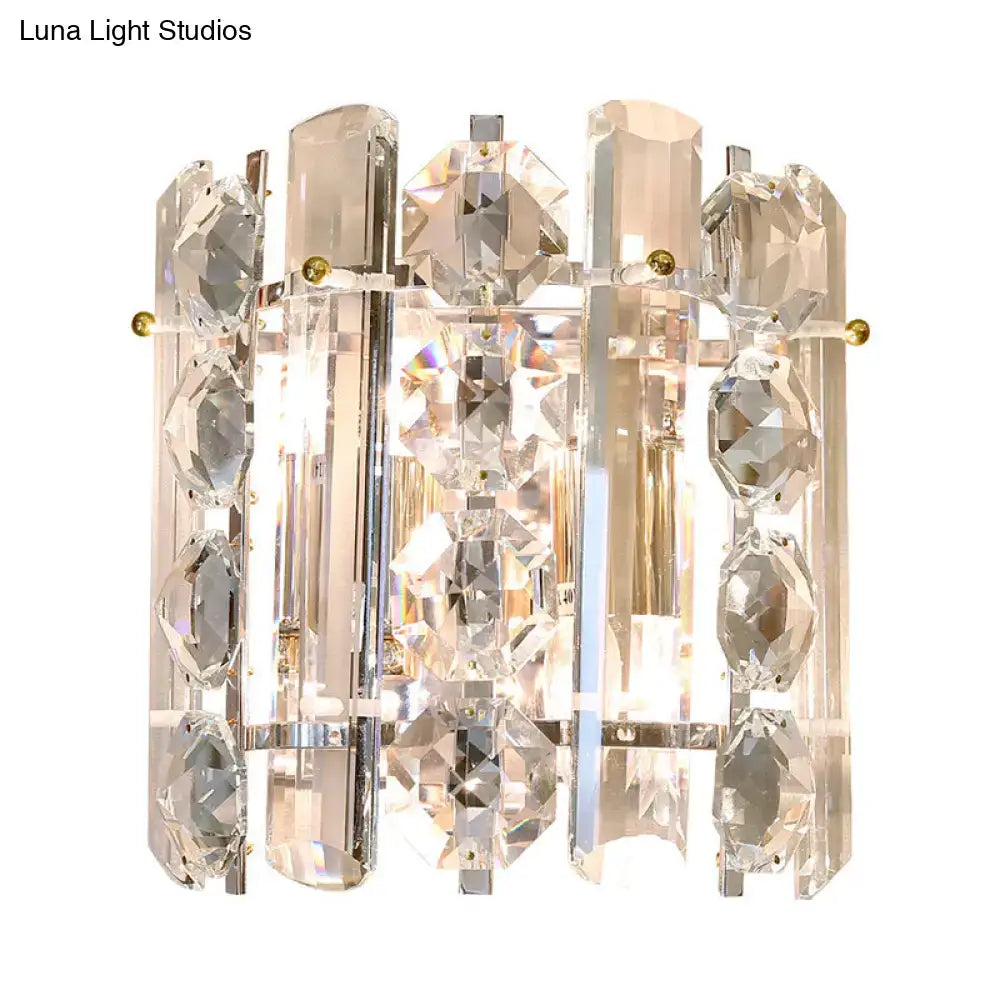 Contemporary chrome 2-light wall lamp featuring clear crystal with faceted geometric shapes and gold-toned accents