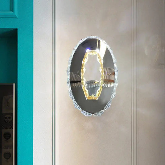 Contemporary chrome crystal oval light fixture mirror with beveled frame and warm white illuminated gold-toned element