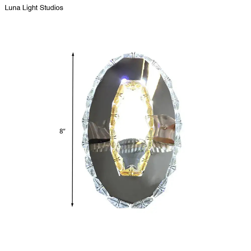 Contemporary chrome crystal oval light fixture with warm white beveled frame and chandelier light fixture height for bedroom mirror