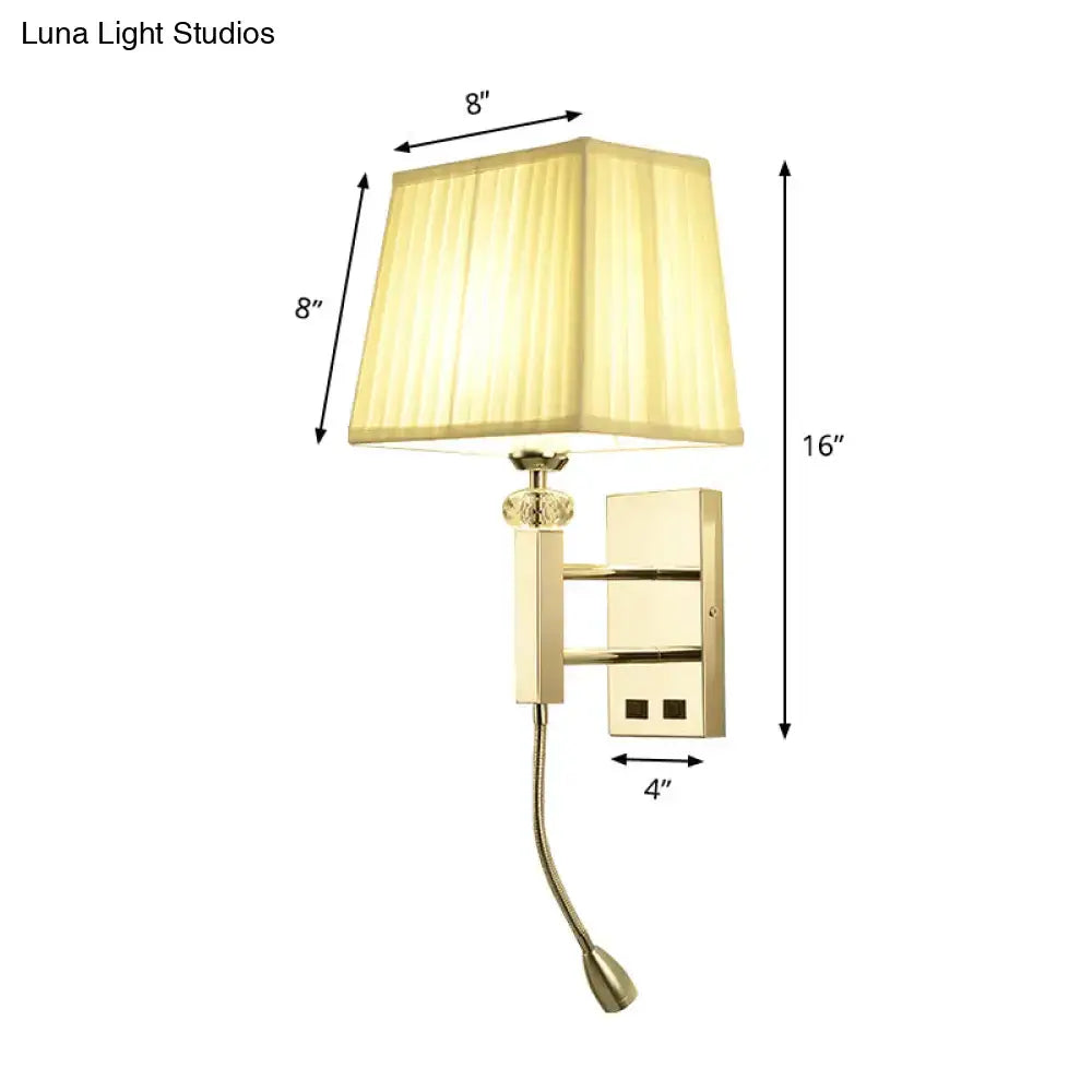 Gold-finished wall sconce light fixture with square beige lampshade and adjustable spot light for bedroom use
