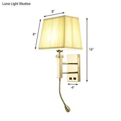 Gold-finished wall sconce light fixture with square beige lampshade and adjustable spot light for bedroom use