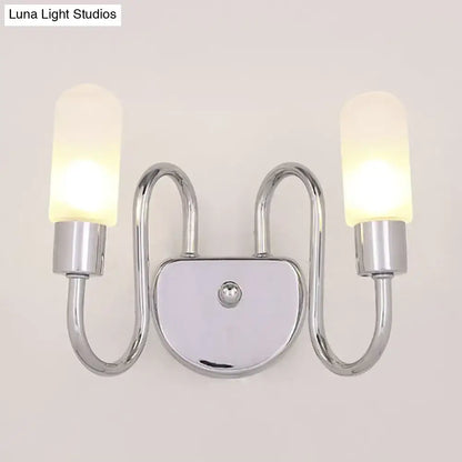Contemporary chrome double-arm wall sconce with frosted milk glass shades for bedroom lighting