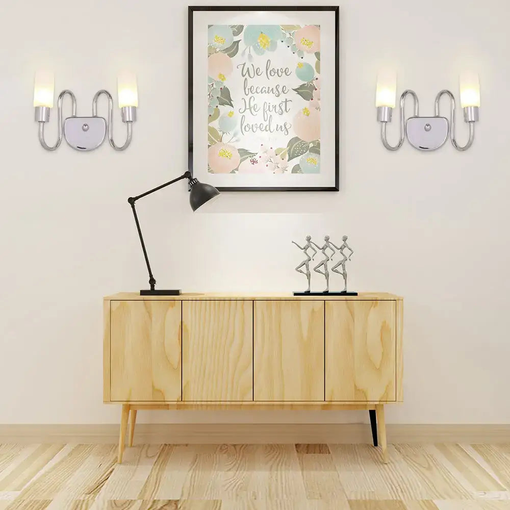 Contemporary silver curved wall sconce with two upward lights and central circular accent for bedroom lighting