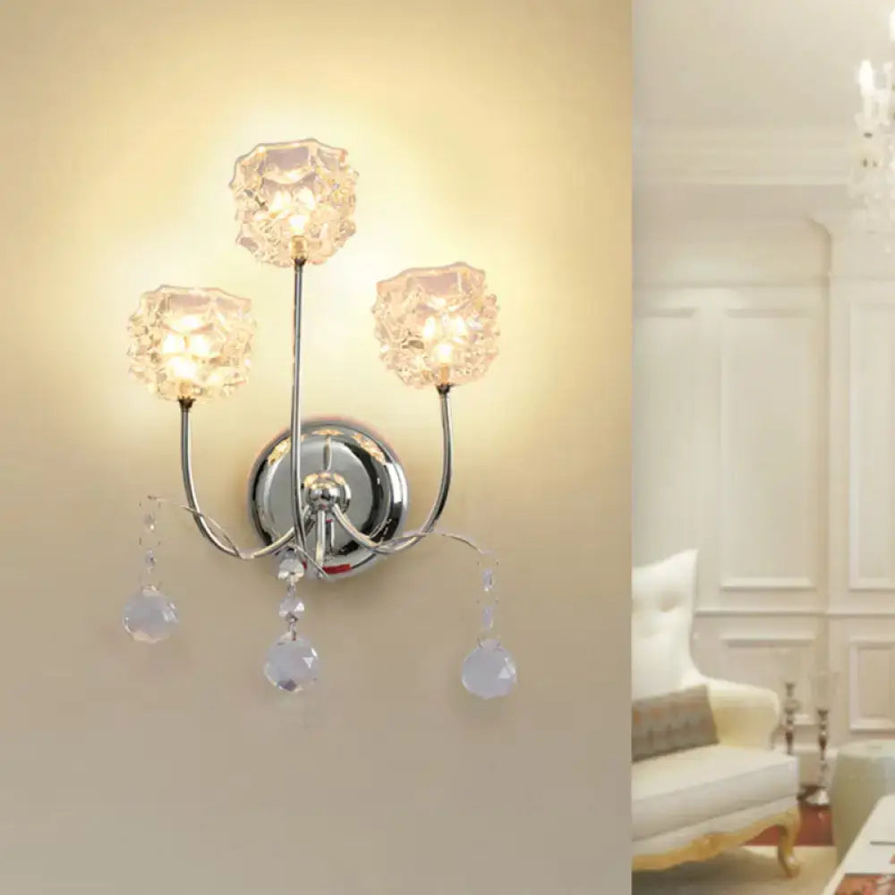 Contemporary chrome wall sconce with three faceted crystal shade fixture and dangling teardrop crystals for living room