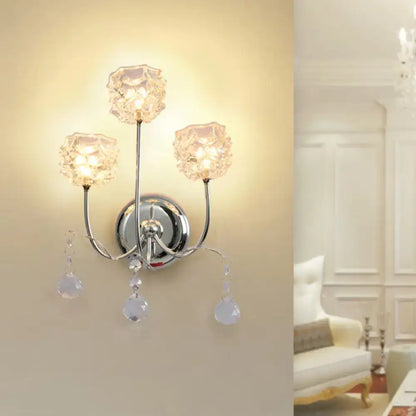Contemporary chrome wall sconce with three faceted crystal shade fixture and dangling teardrop crystals for living room