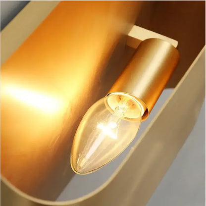A warm-toned contemporary copper brass wall sconce with clear glass candle bulb for living room decorbites contemporary copper