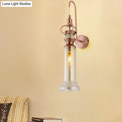 Contemporary copper wall sconce with a smoke gray amber glass shade and rose gold metal frame featuring exposed bulb